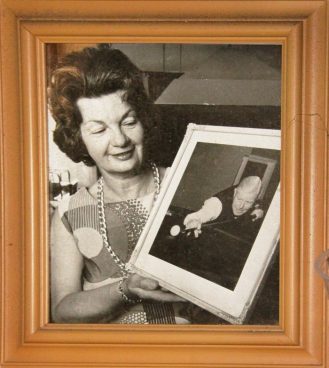 Dolly Lindrum with a photo of her uncle Walter Lindrum