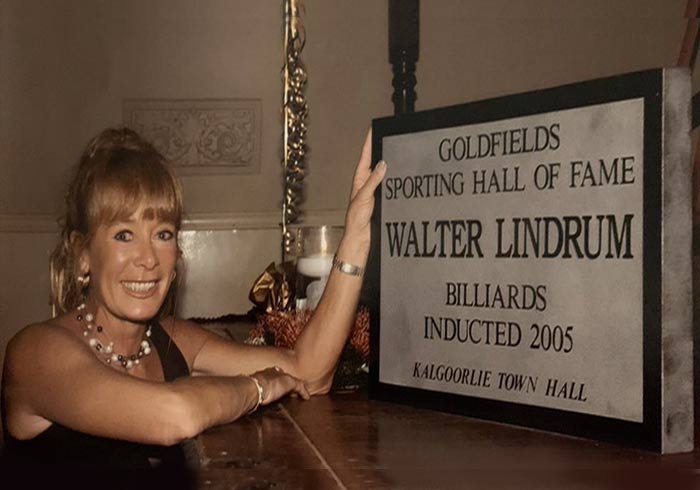 Tammy Lindrum with Walter Lindrum's Hall of Fame inductee plaque in Kalgoorlie Town Hall